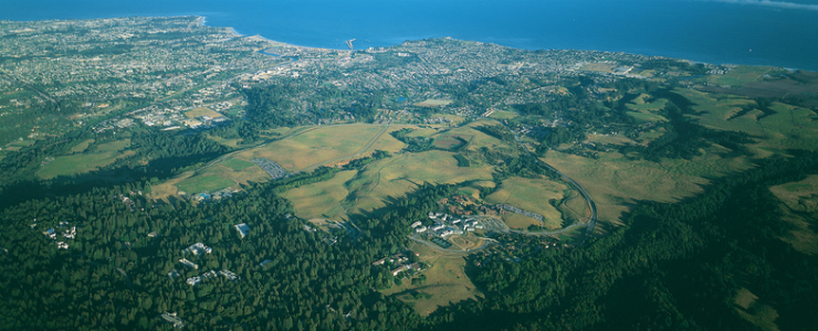 Aerial view of UC Santa Cruz campus with Monterey Bay National Marine Sanctuary and the city of Santa Cruz as backdrop